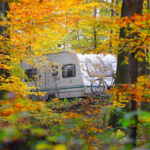 Caravan,Trailer,With,A,Bicycle,And,A,Car,Parked,In